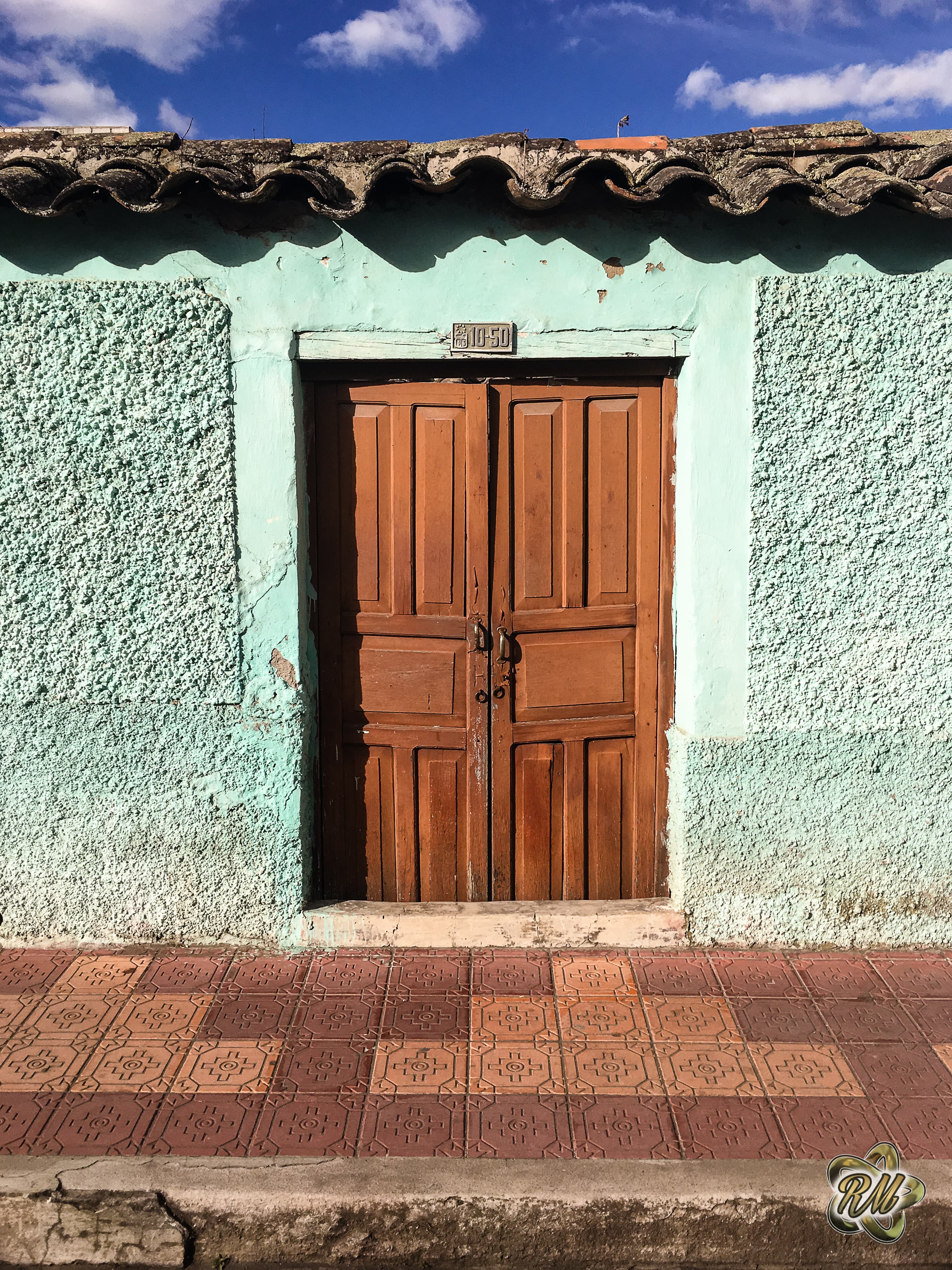 Aged blue wooden door set into a stone wall