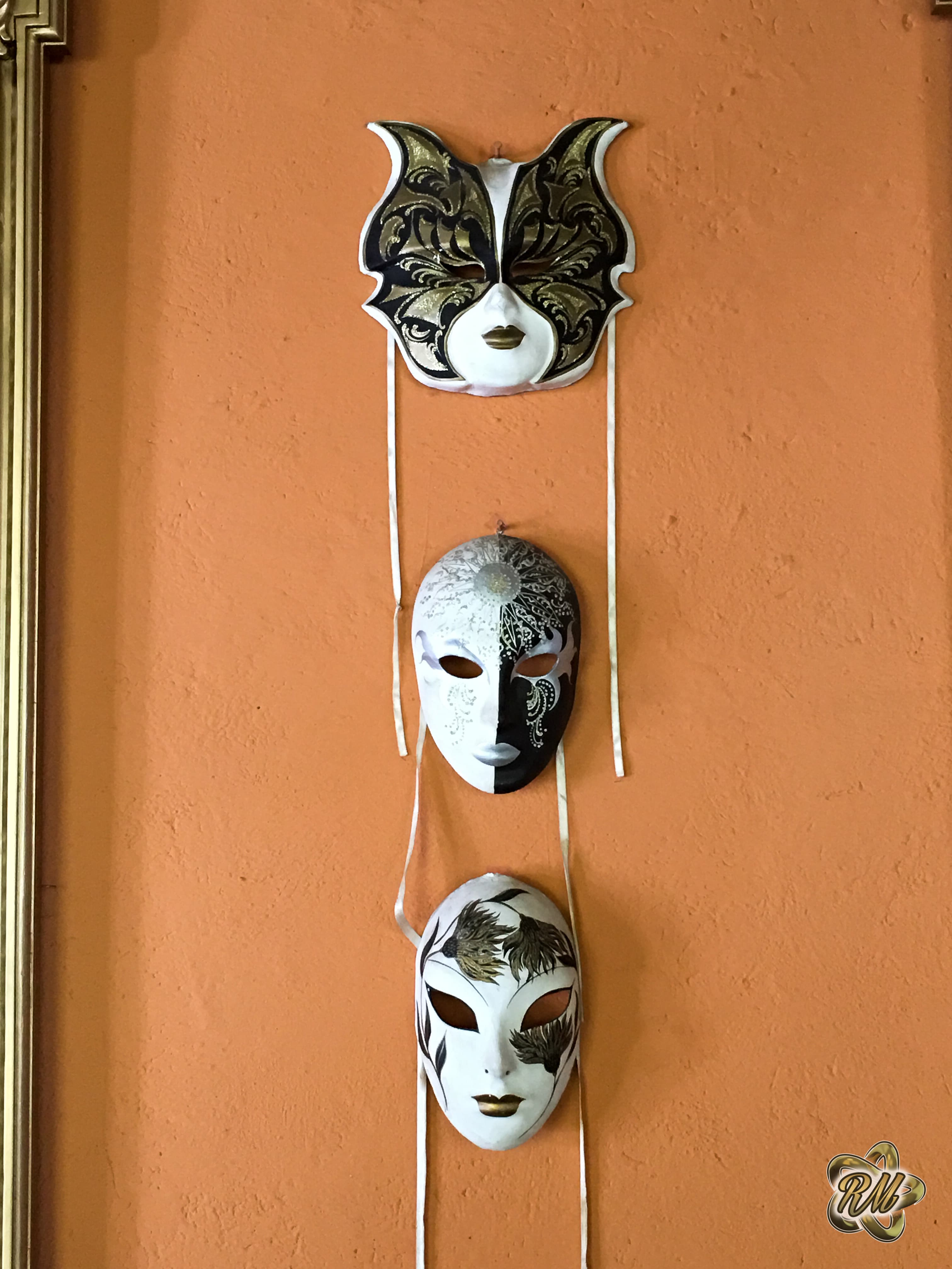 Trio of antique door handles on a warm-toned wall
