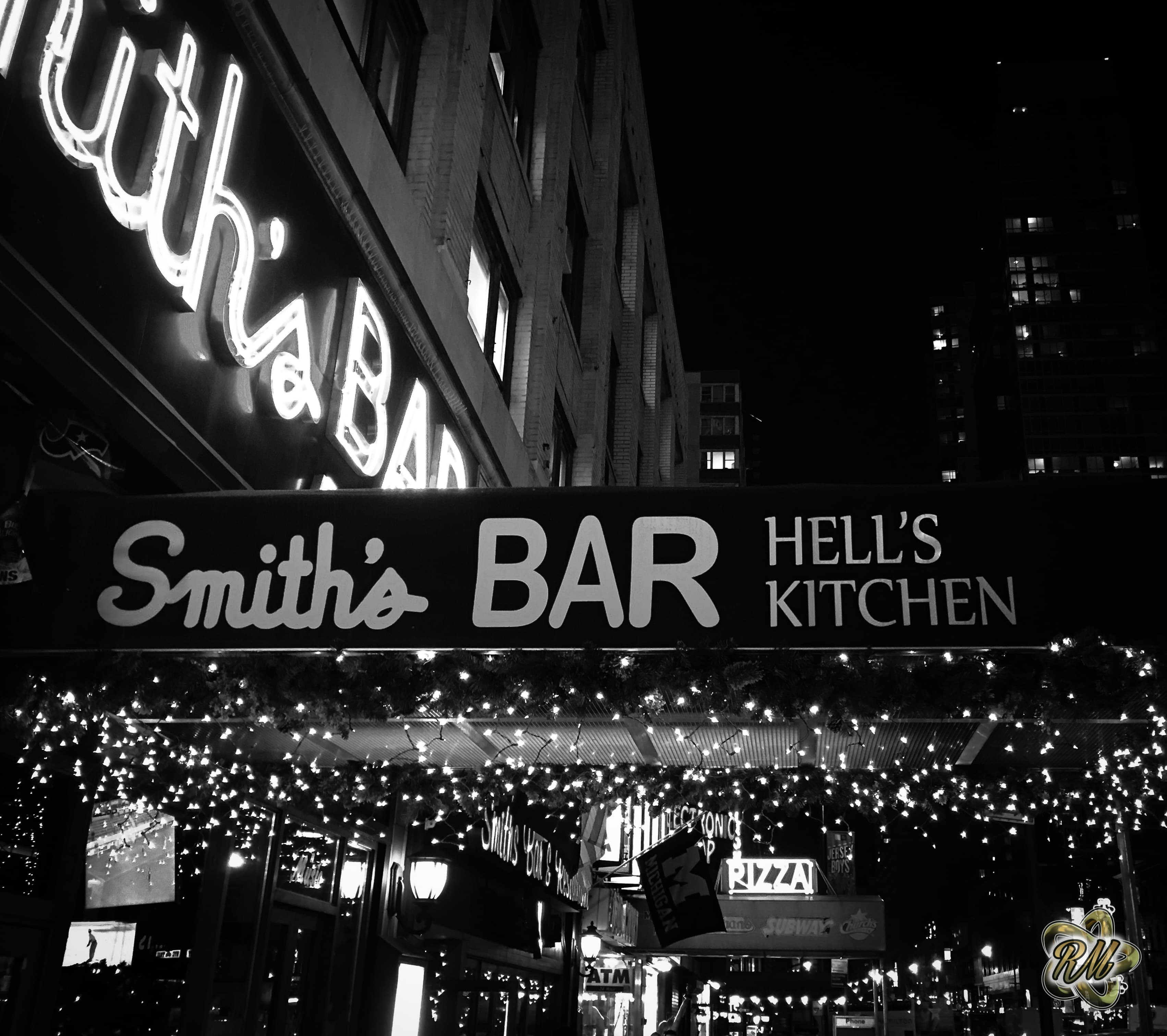 Smith’s Bar neon sign on a city corner at night
