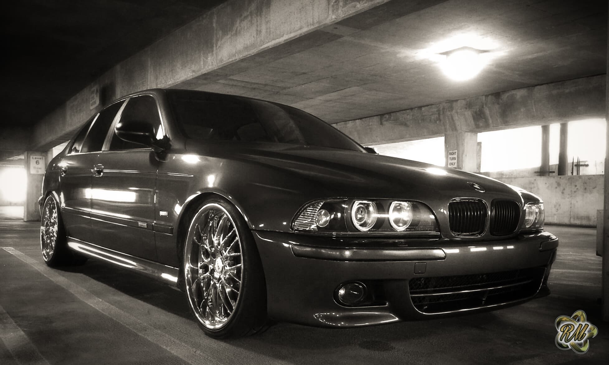 Black-and-white BMW parked on a quiet street at night